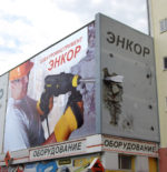 drilling through corner of building billboard