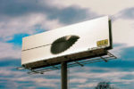 saw blade cutting through billboard