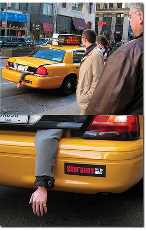 vehicle-advertising sopranos hand out of taxi trunk
