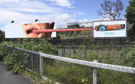 tongue stretching between two billboards chille mars bar