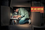 business moving print ad with man working inside cardboard packing box