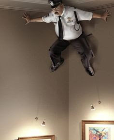 example of visual metaphor - home security - police officer on lookout from ceiling corner